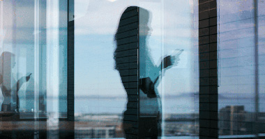 Woman using a phone through a window