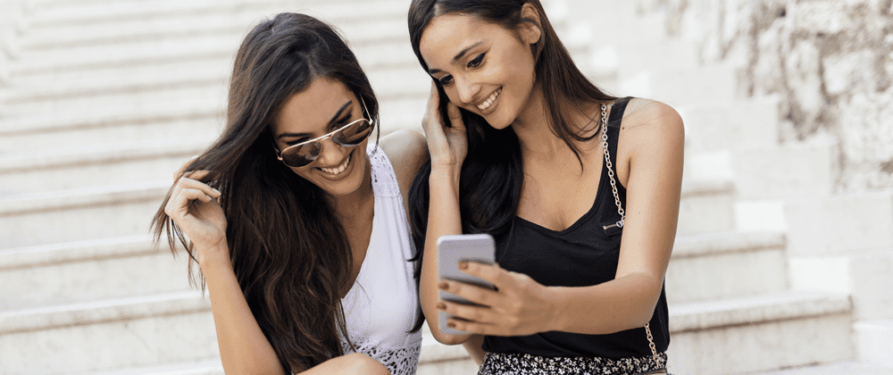 Two woman looking at a phone