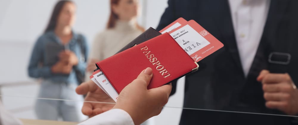 Person holding passport and airline ticket