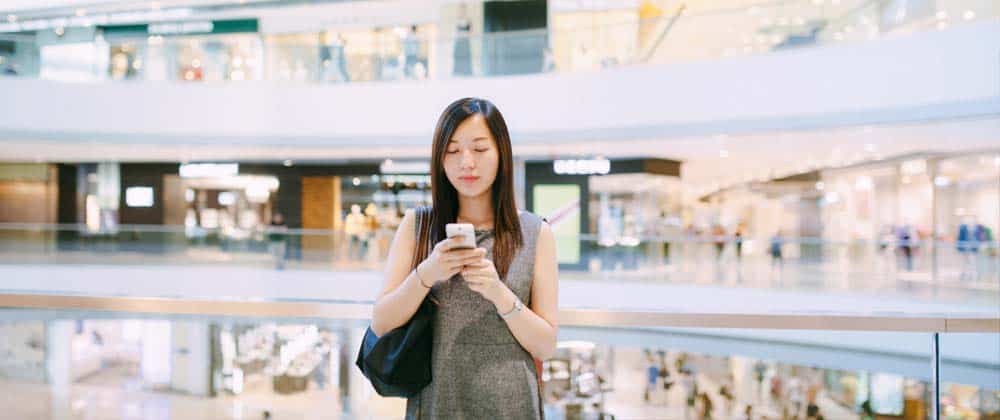 Woman using a phone in a mall