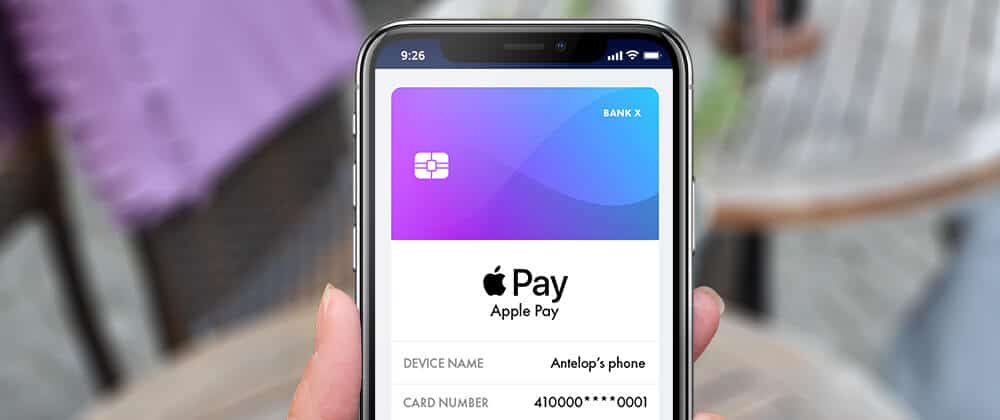 hand holding phone with apple pay app shown on screen
