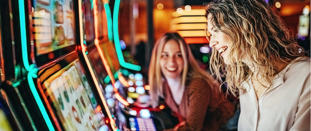 Two woman playing games at a casino