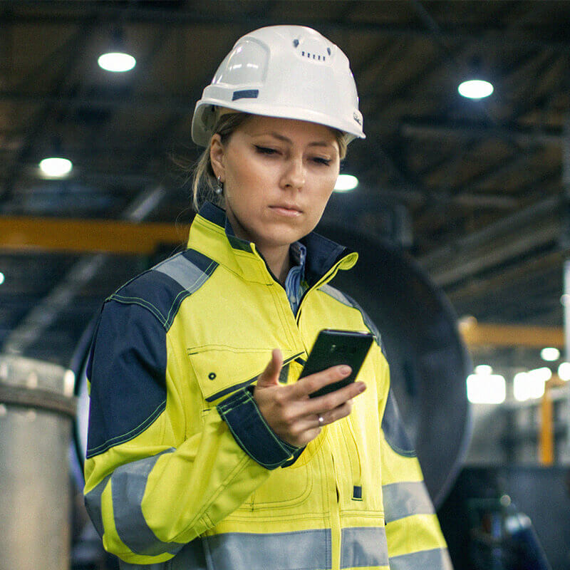 Woman in a hard hat using a phone