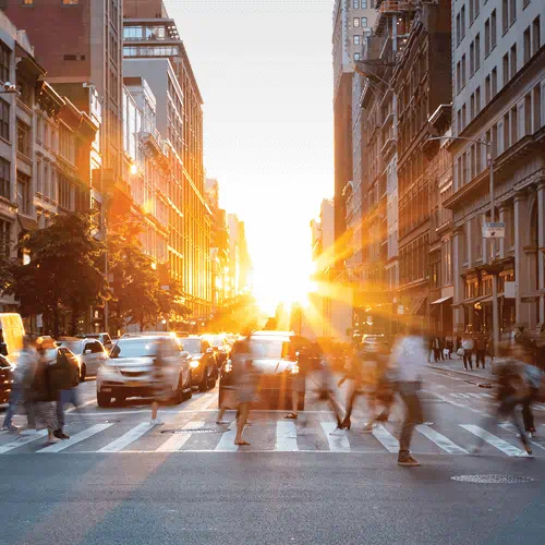 sunrise in middle of busy city street