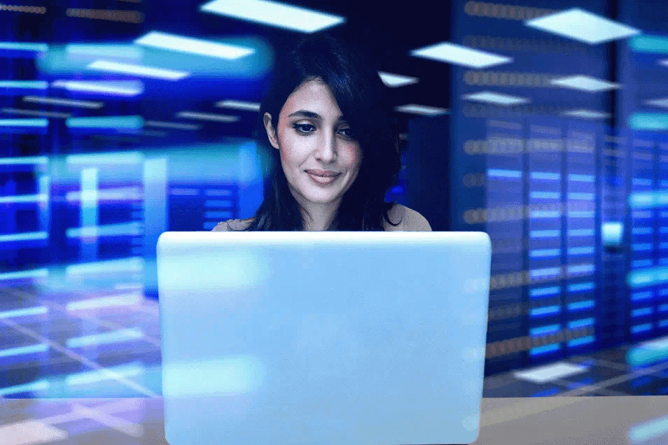 woman behind glass looking at computer screen