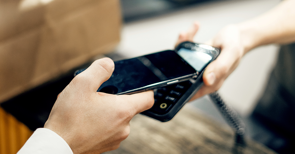 Person scanning a phone for digital payment
