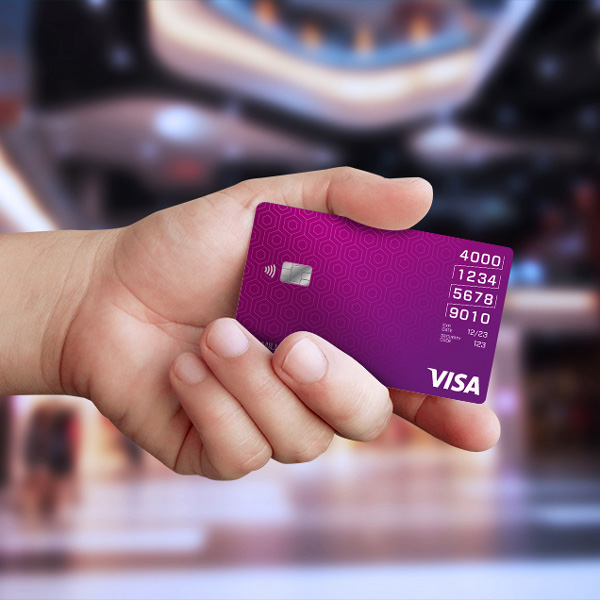 hand holding purple VISA card