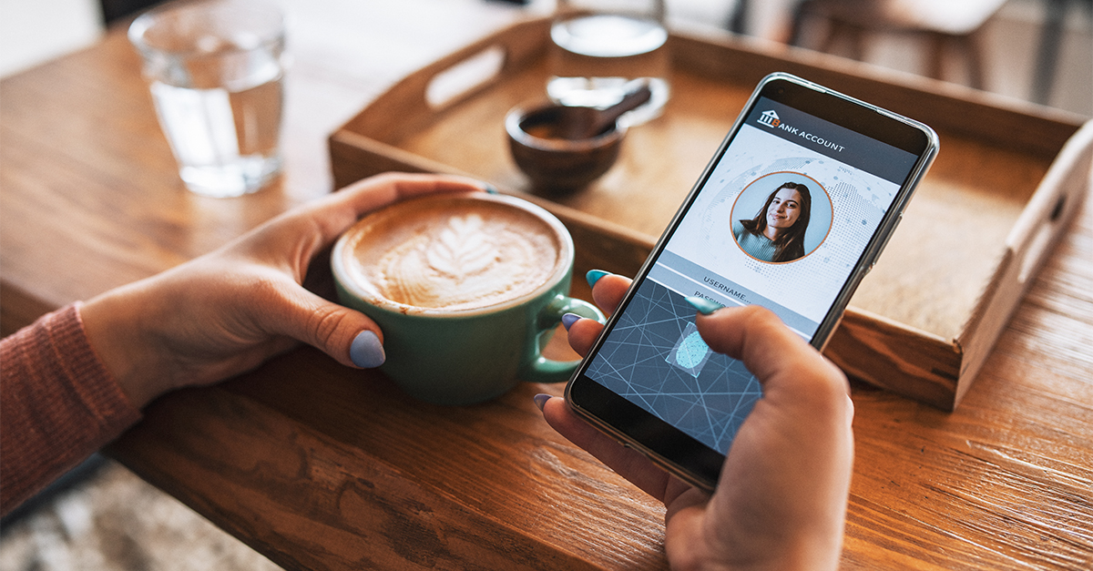 Person holding phone and coffee