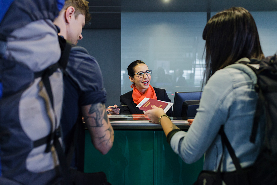travelers with passport at counter