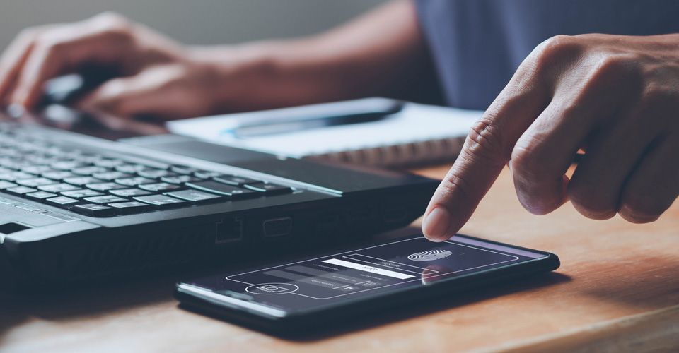 woman's hand uses mobile device for multi-factor authentication