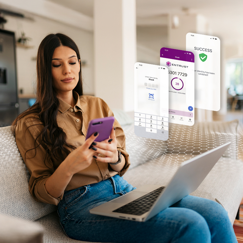 Person using a smartphone with a laptop nearby and authentication app screens floating beside them
