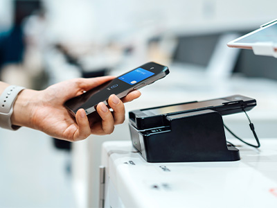 Hand using a mobile wallet app to make a contactless payment