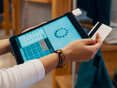 Point‑of‑sale tablet with a credit card being swiped