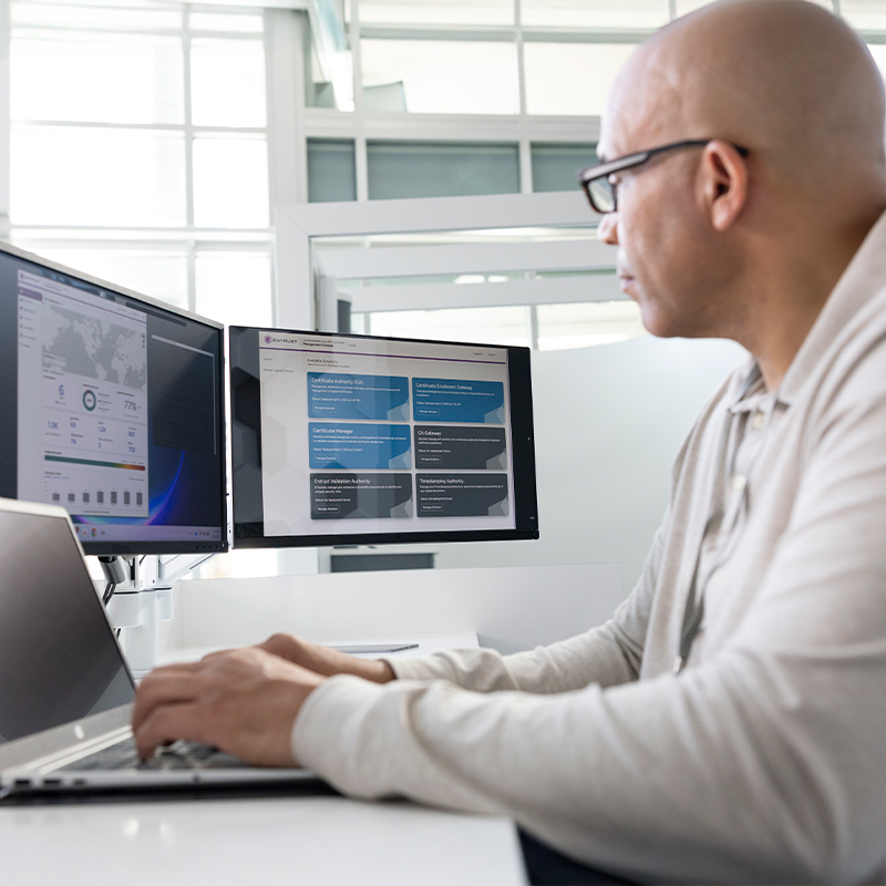 man at computer with multiple monitors