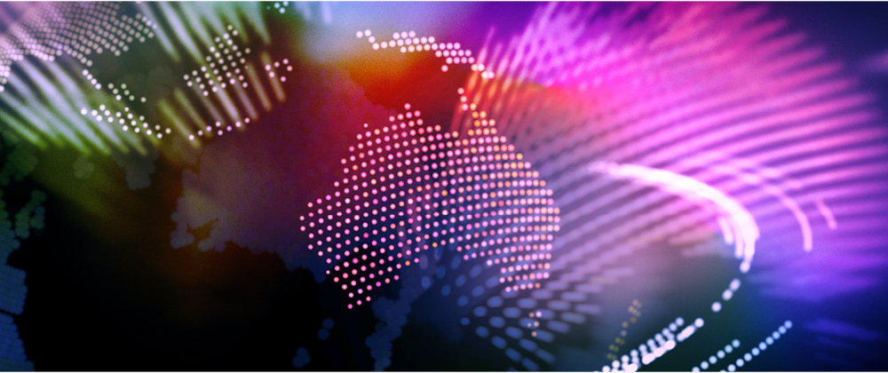 Abstract digital map of Australia formed by pink dots over a colorful, flowing background of light and motion