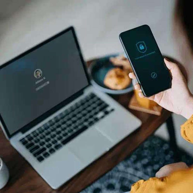 woman using phone for laptop login