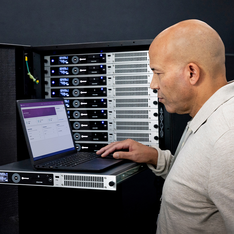 Person using a laptop to manage Entrust nShield HSMs in a server rack