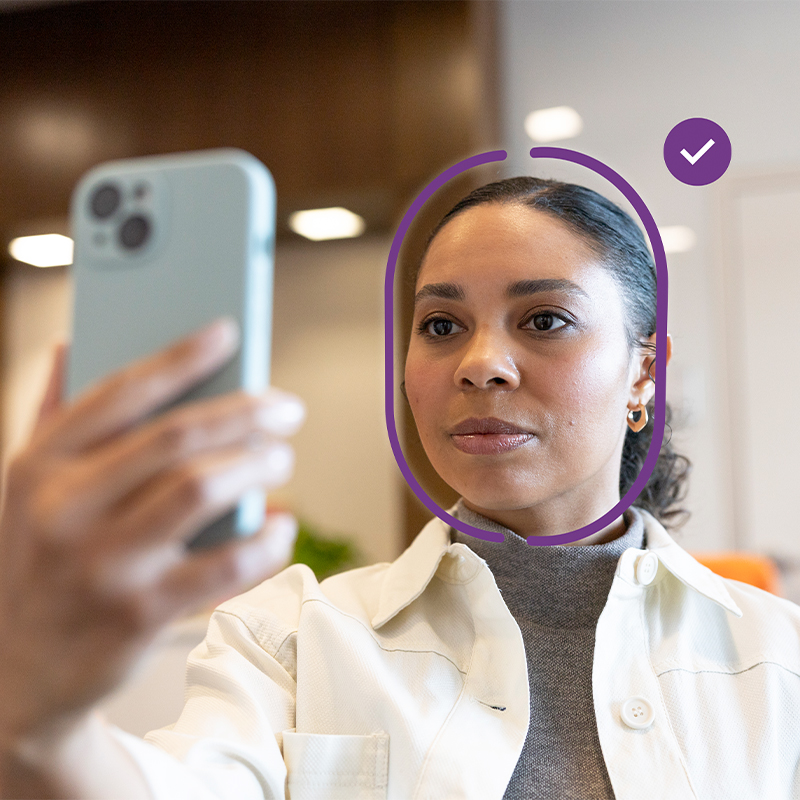 Person using a smartphone for facial identity verification