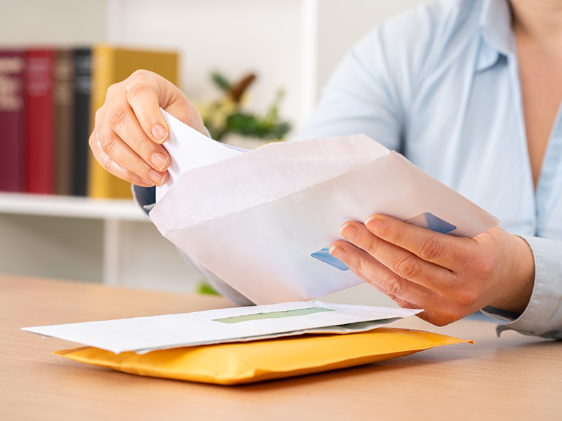 Close up of person opening an envelope