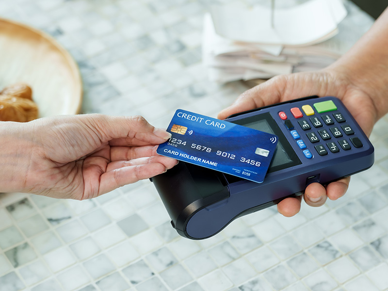 Close up of person tapping financial card for payment 