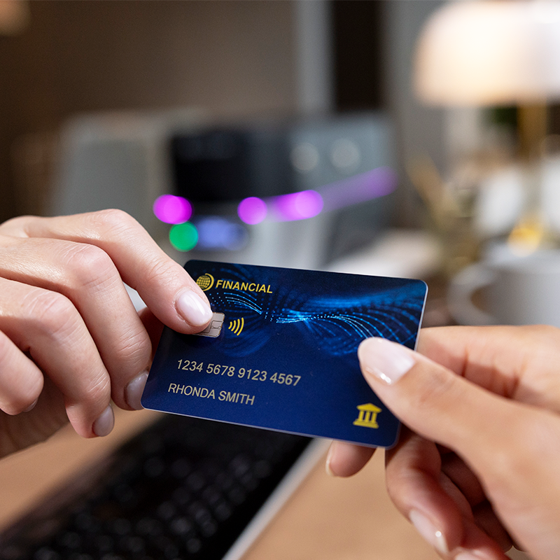 two hands holding a financial card
