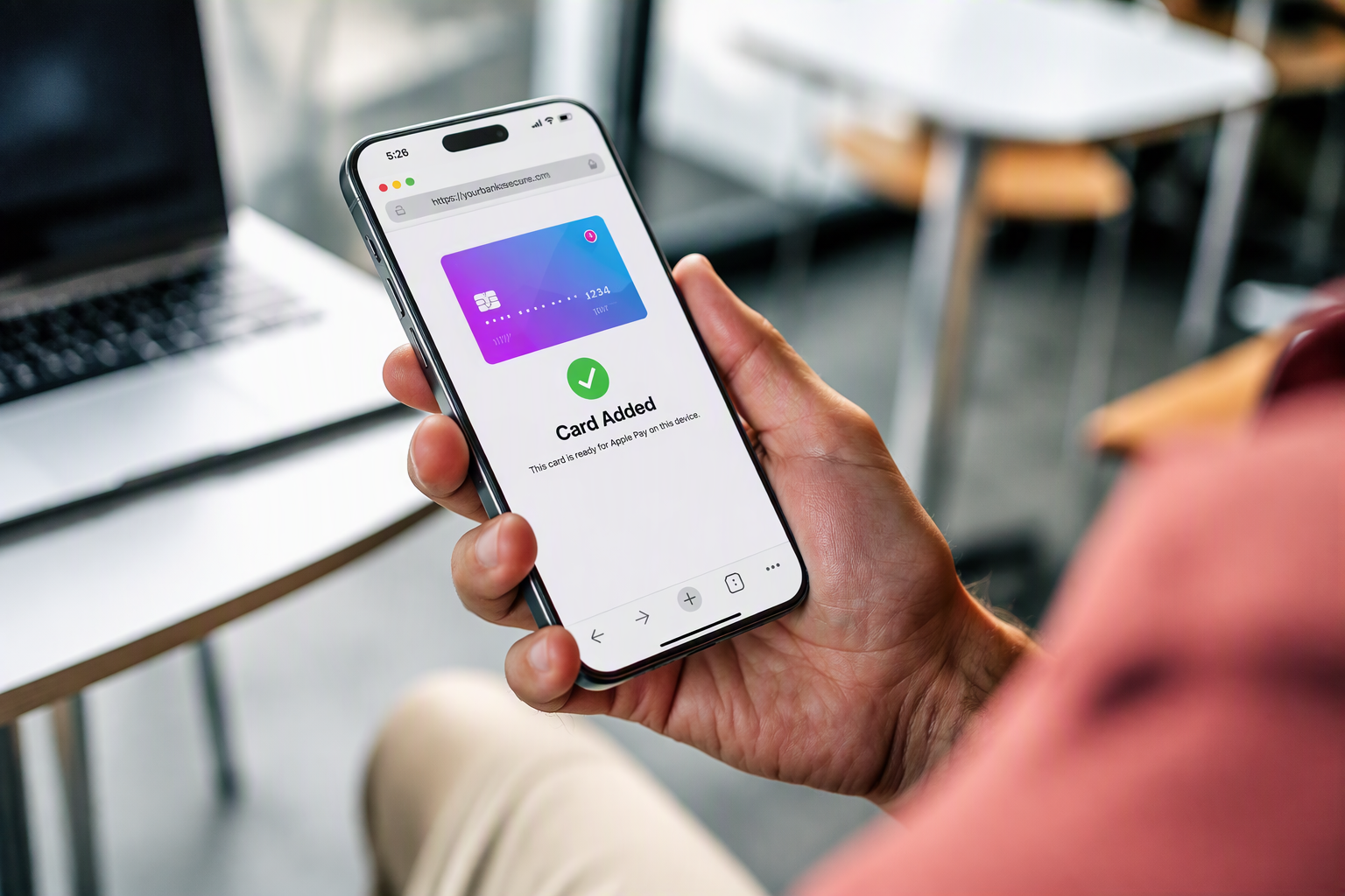 Close up of someone's hand holding a cellphone with a digital wallet app 