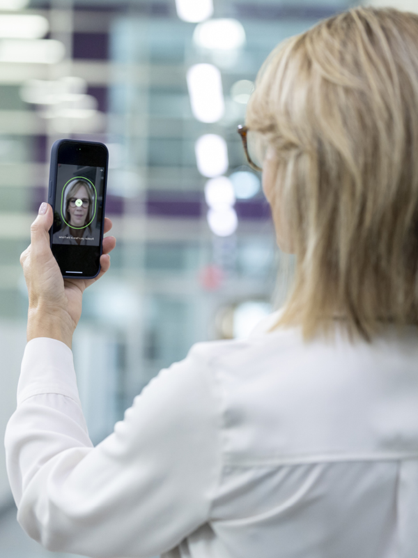 woman holding phone for biometric authentication