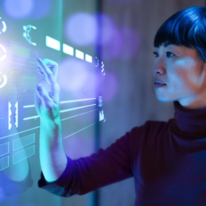 woman at large wall computer screen