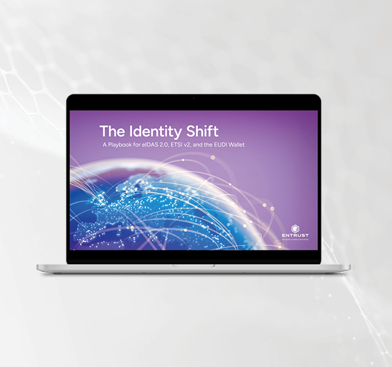 Laptop displaying "The Identity Shift" eBook cover with global digital identity network graphic