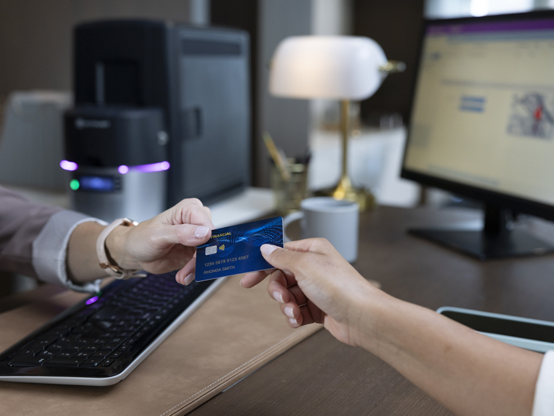 Close up of hands holding a financial card