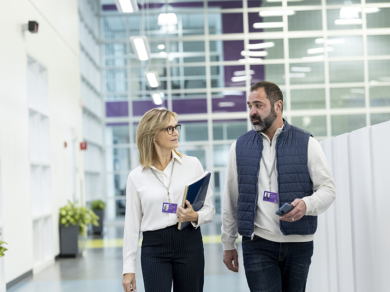 Two employees walking around an office