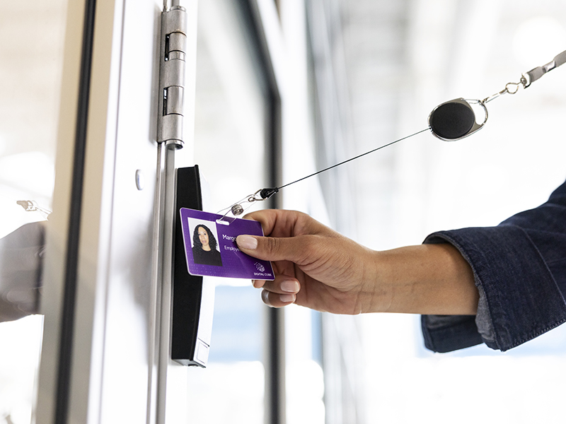 Person scanning ID card into building 