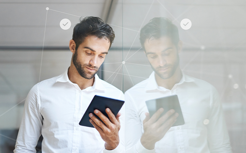 Person using a tablet with digital identity verification icons and network connections overlaid