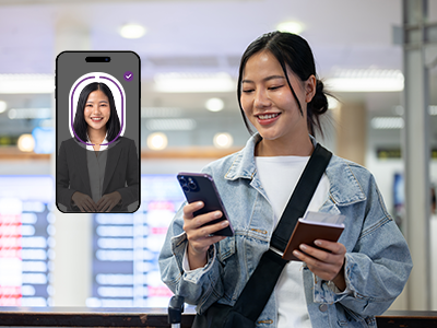 Person using a mobile phone to complete identity verification with facial recognition